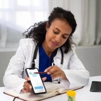 female-doctor-holding-smartphone-showing-medial-app (1)