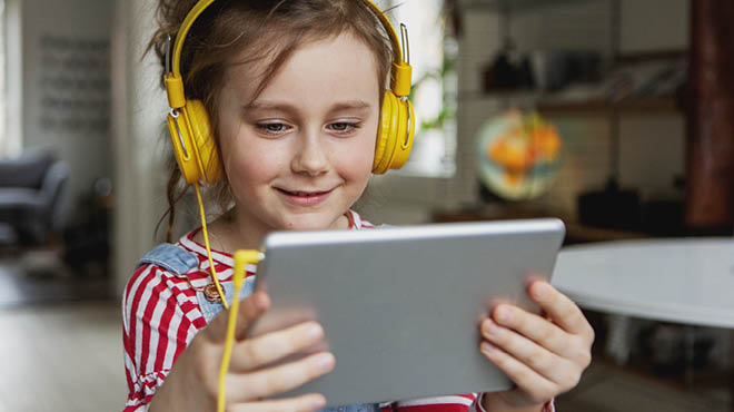 child-wearing-earphones-using-tablet