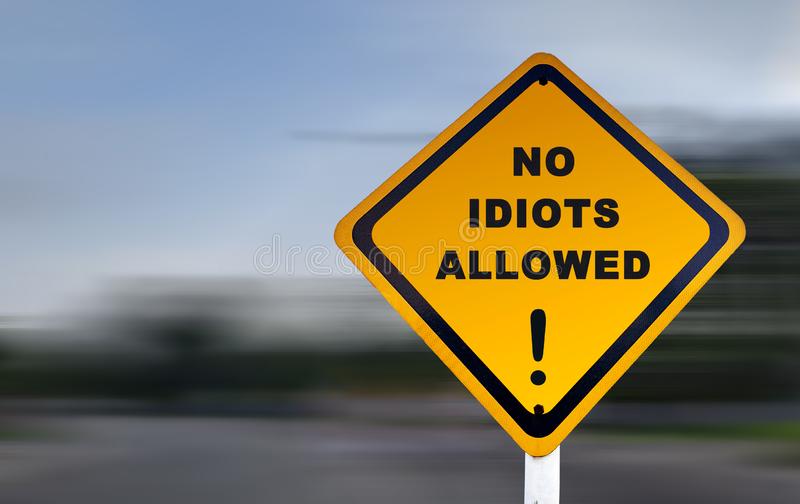 funny-road-sign-no-idiots-allowed-exclamation-mark-text-set-against-speed-blurred-background-140649531