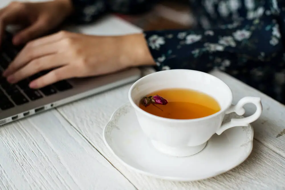 woman-working-hot-cup-floral-tea (1)