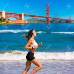 38995233-brunette-girl-running-on-the-beach-san-francisco-golden-gate-bridge-photo-mount