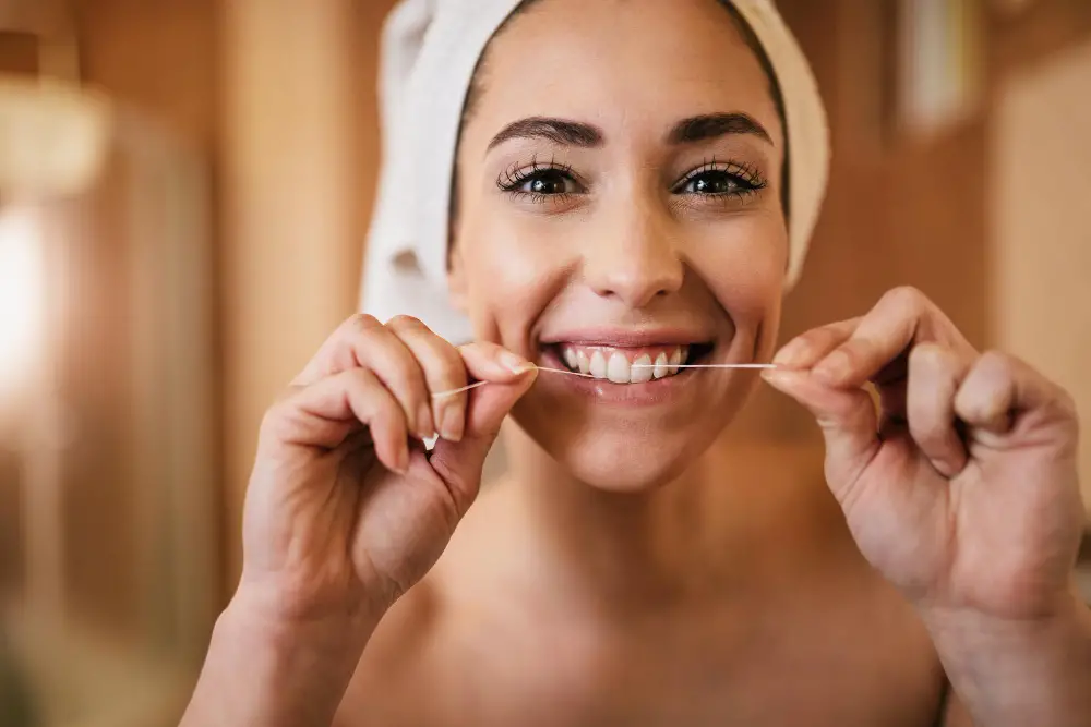 beautiful-woman-using-dental-floss-cleaning-her-teeth-bathroom (2)