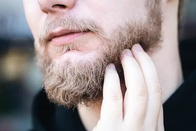 closeup-young-man-touches-his-beard-with-his-hand_169016-25532