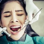 dentist-examines-patient-s-teeth