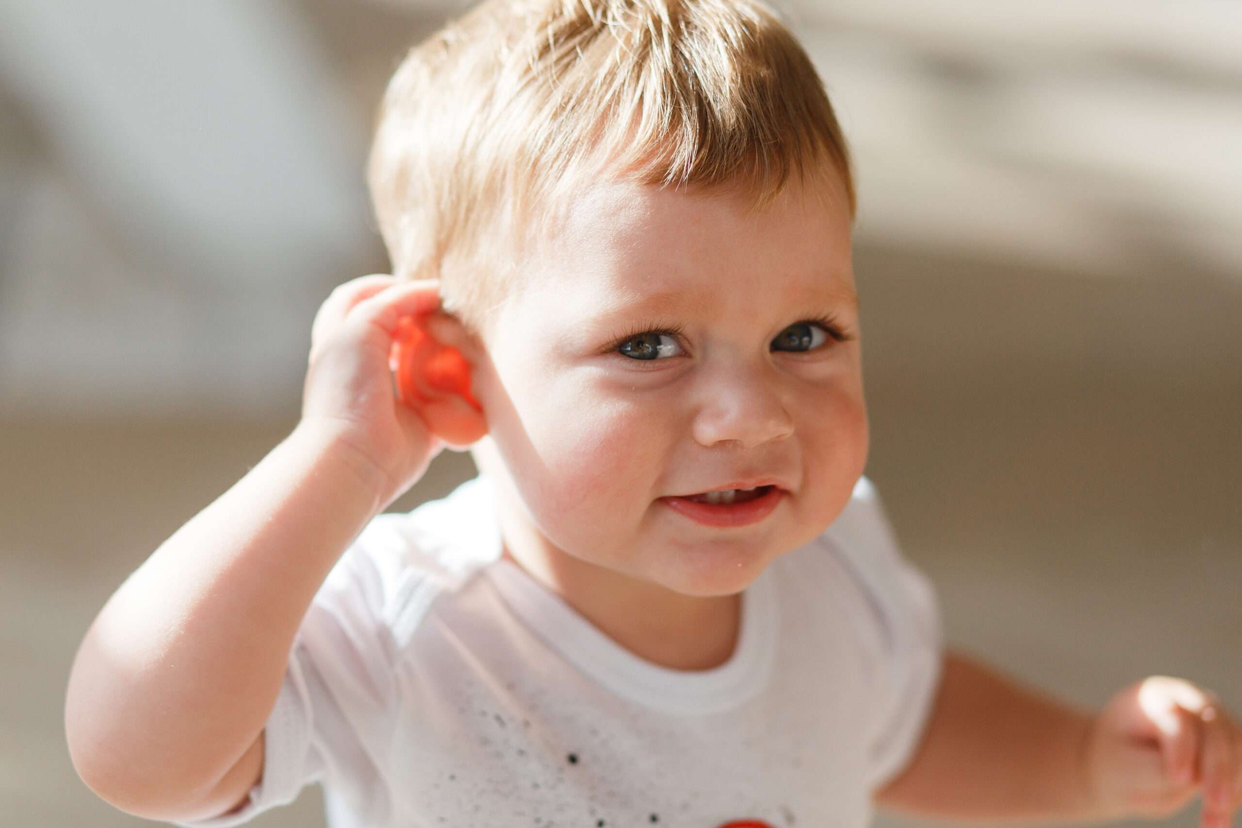 baby-boy-listens-put-hand-his-ear-scaled