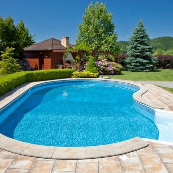 odd-shape-pool-on-a-sunny-clear-day-picture-id153501870