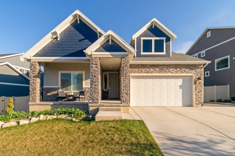 Brown concrete house with a garage door