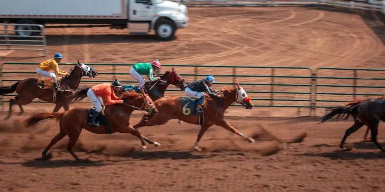  Jockeys racing on a horse racing track