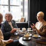 elderly-women-drinking-coffee-talking-during-gathering_11zon (1)