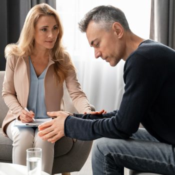 mid-shot-woman-therapist-comforting-patient