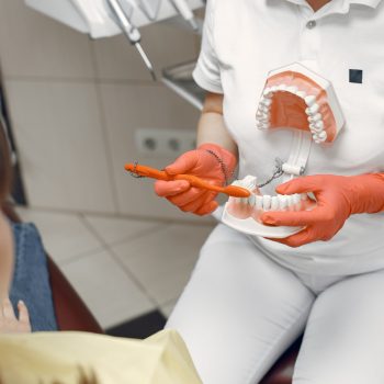 woman-dental-chair-dentist-teaches-proper-care-beauty-treats-her-teeth