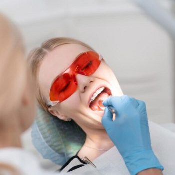 young-woman-opening-her-mouth-during-dental-examination_317809-11421