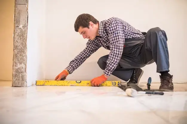 home-tile-improvement-handyman-with-level-laying-down-tile-floor_231208-6795