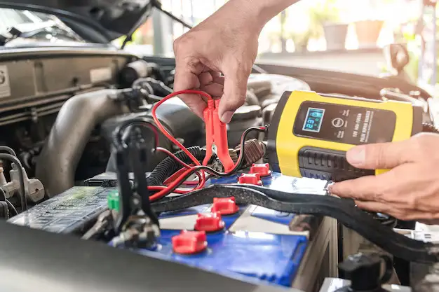 car-mechanic-is-using-voltage-measuring-instrument-charging-battery_47469-406