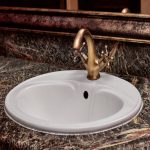 closeup-brass-faucet-with-hot-cold-handles-white-lavatory-sink-restroom