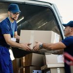 delivery-men-loading-carboard-boxes-van-while-getting-ready-shipment