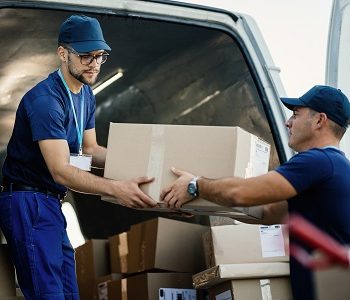 delivery-men-loading-carboard-boxes-van-while-getting-ready-shipment