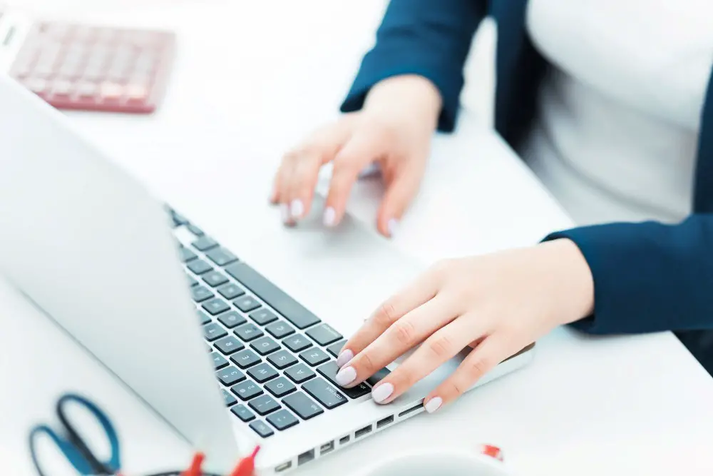 female hands on the keyboard of her laptop computer