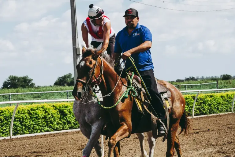 two men riding horses