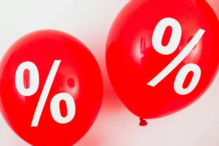 A photo showing red balloons with percentage symbols printed onto them