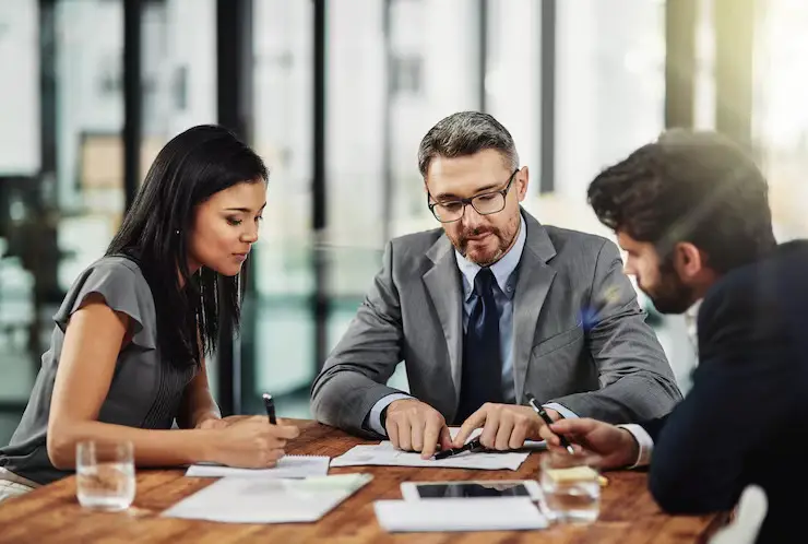 its-meeting-minds-shot-three-colleagues-sitting-around-meeting-tablet-office_590464-21953