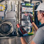 man-electrical-technician-working-switchboard-with-fuses (1)