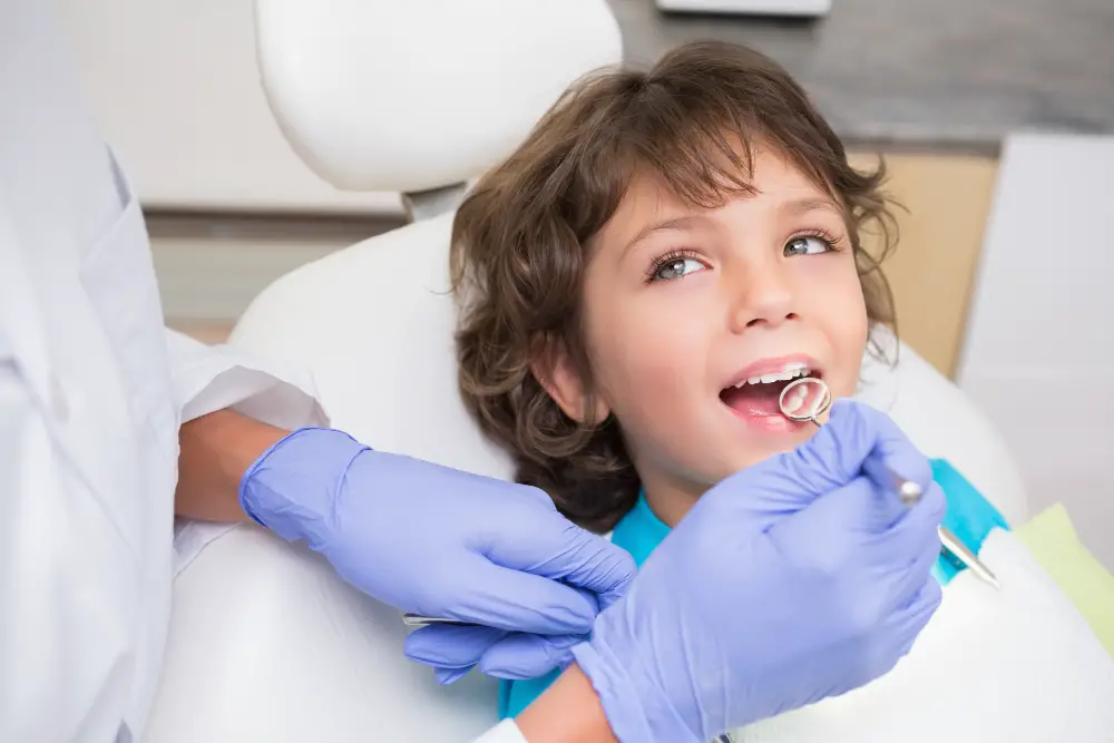pediatric-dentist-examining-little-boys-teeth-dentists-chair (1)