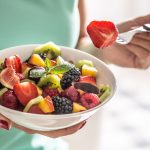 woman-breakfasts-a-fruit-salad-high-in-vitamins-and-royalty-free-image-1690494564