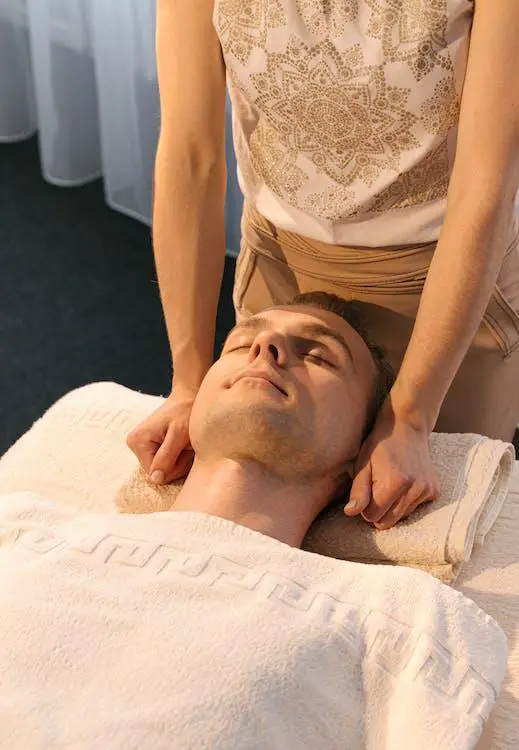 A man enjoying an In-room Massage in his hotel room