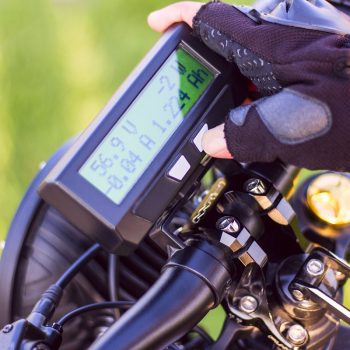 close-up-man-hand-clicking-mode-button-monitor-electric-bike