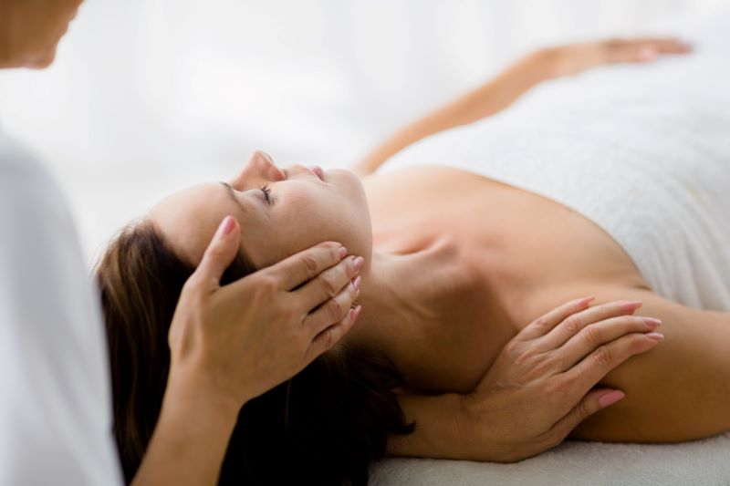 cropped-masseur-giving-massage-woman