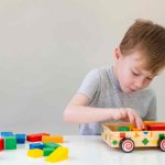 jpeg-optimizer_little-boy-playing-with-wooden-car