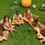 kids-fashion-concept-group-teen-boys-girls-sitting-green-grass-park (1)