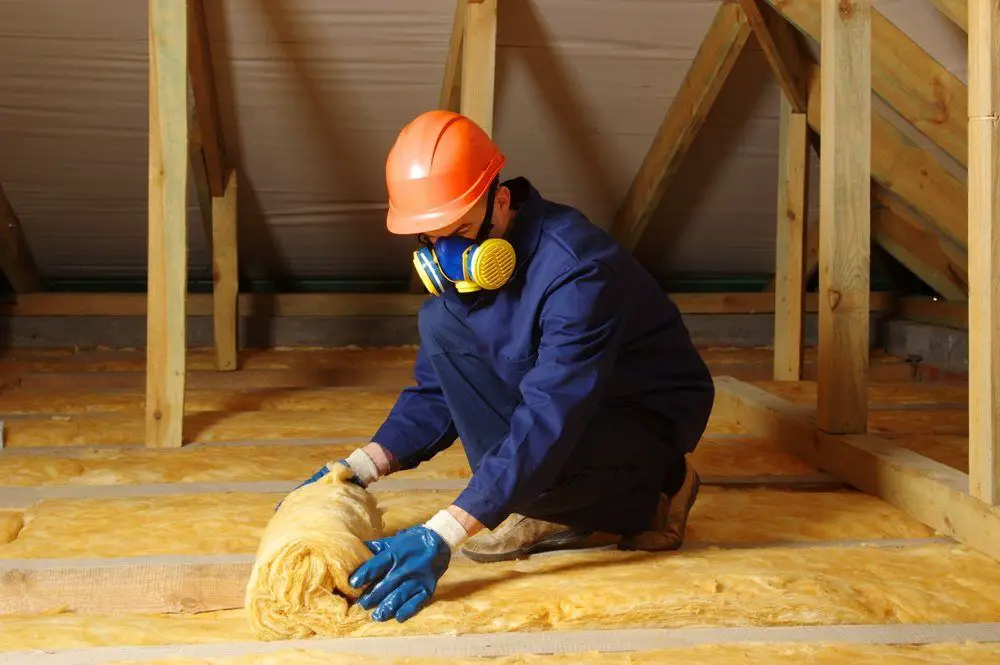 A man is working insulation Construction house. (1)