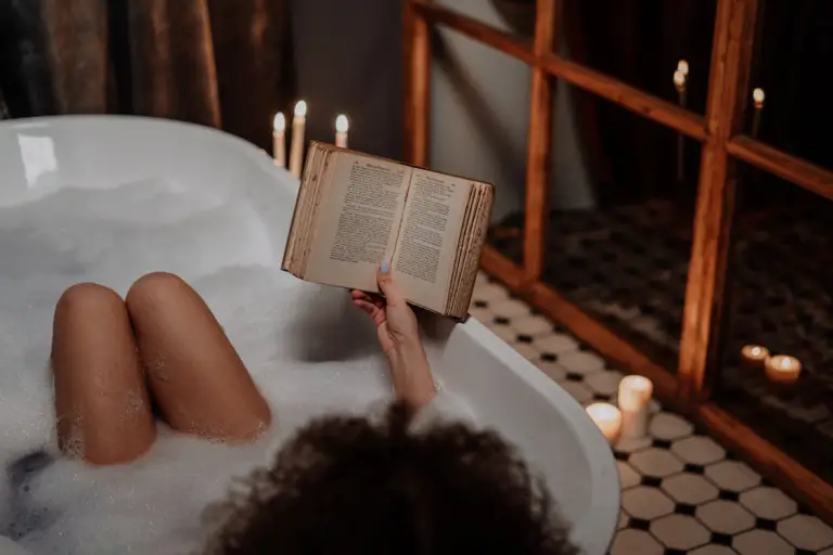 A person reading a horror book in a bathtub