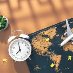 alarm-clock-airplane-miniature-world-map-brown-background-flat-lay_169016-28234