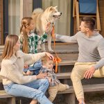 girl-man-touching-dog-woman-with-child