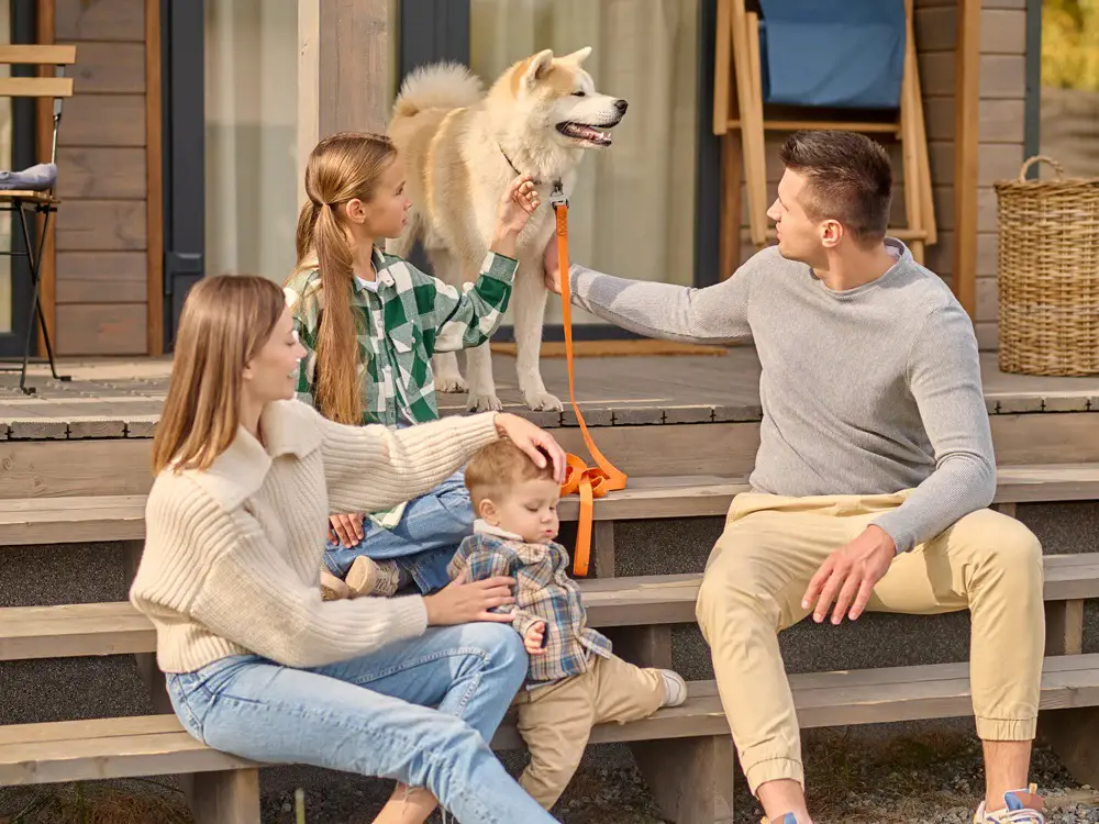 girl-man-touching-dog-woman-with-child