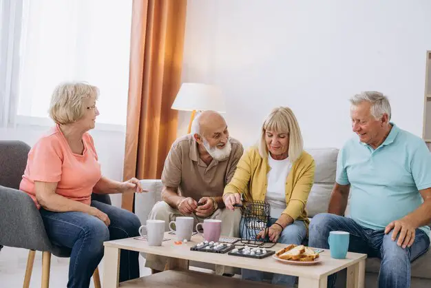 group-four-cheerful-senior-people-playing-bingo-game-nursing-home_1429-12758
