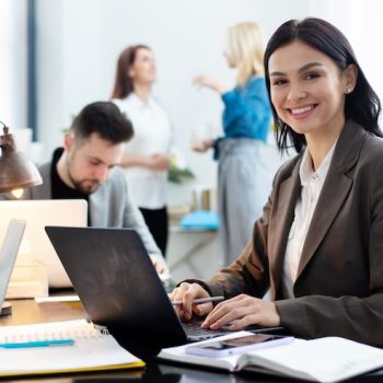 A woman with a laptop is doing accounting work.