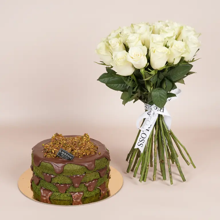 A pistachio and Nutella cake with a bouquet of flowers.