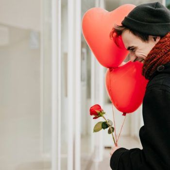 cheerful-young-man-with-balloons-street_23-2147736109