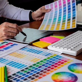 midsection-entrepreneur-using-graphic-tablet-while-holding-color-swatch-desk-office_1048944-23869103