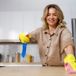 woman-spraying-cleaner-and-disinfectant-on-wooden-2022-06-23-18-06-11-utc-1200x800