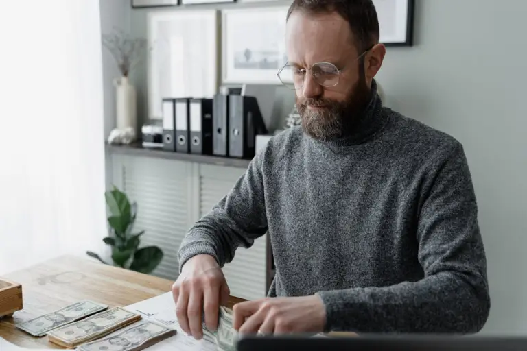 A person holding a stack of cash in their hand