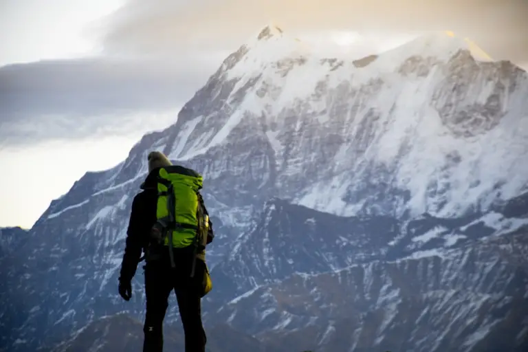 A hiker standing at a mountaintop
