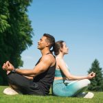 man-woman-practicing-yoga-outdoor_23-2148196902