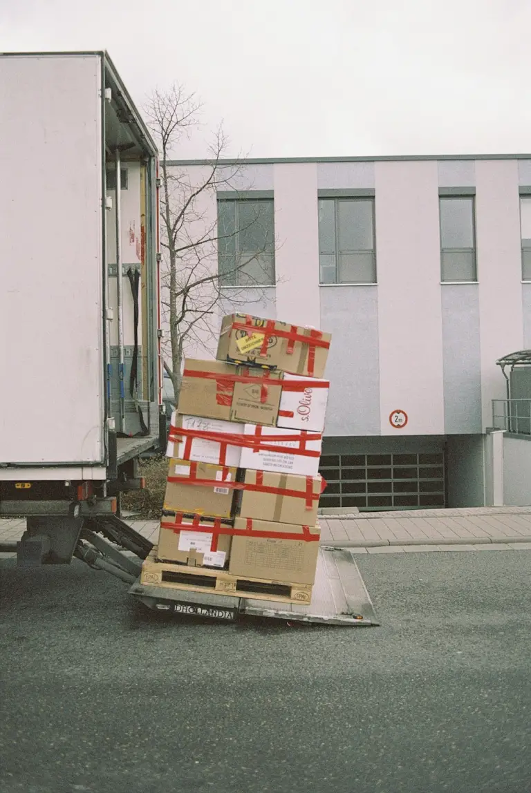 Packed brown boxes are being moved to the truck