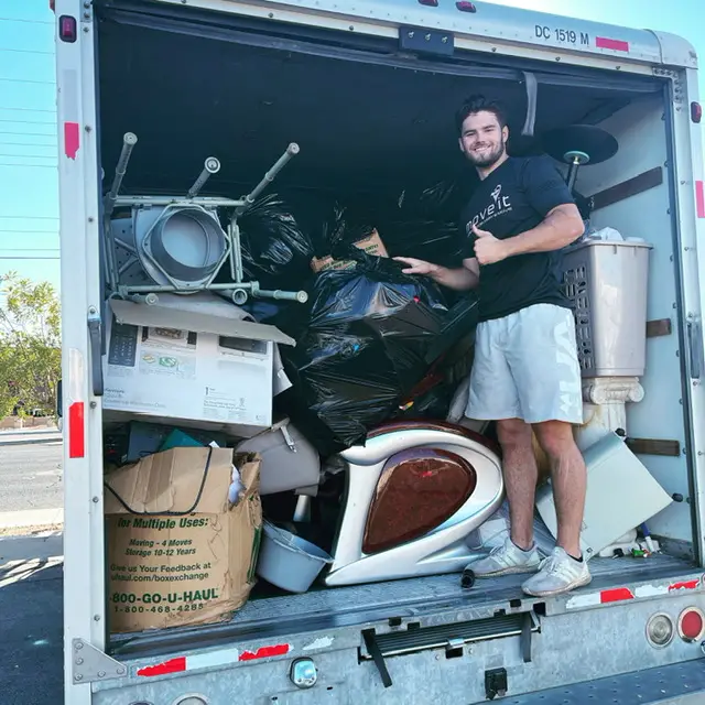 A person in the junk removal truck