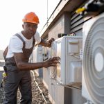 african-man-in-uniform-checking-air-conditioner-on-2023-12-21-22-00-43-utc_1200x800_1_1_optimized